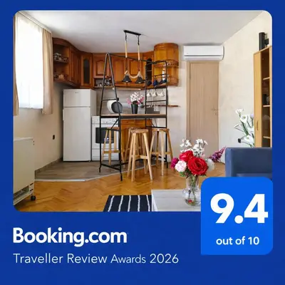 a living room with a kitchen with a table at Apartman AS in Belgrade