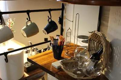 a kitchen with a wooden table with pots and pans at Apartman AS in Belgrade