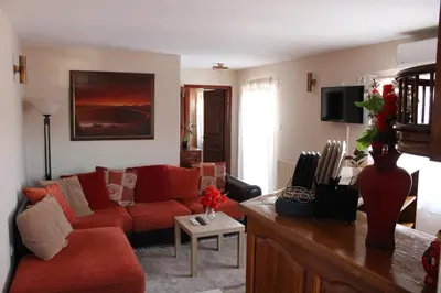a living room with a red couch and a table at Apartman AS in Belgrade
