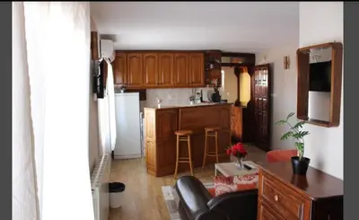 a kitchen with wooden cabinets and a counter top at Apartman AS in Belgrade