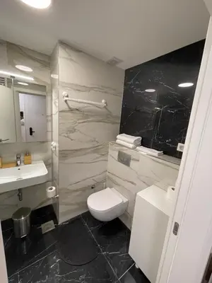 a bathroom with a toilet and a sink at Princess - free parking place in the garage in Belgrade