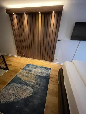 a bedroom with a bed and a rug on the floor at Princess - free parking place in the garage in Belgrade