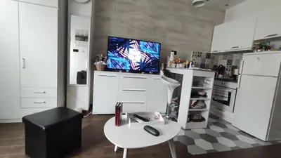 a kitchen with a table and a tv on a wall at Zone Vidikovac in Belgrade