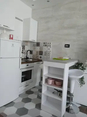 a white kitchen with a sink and a white refrigerator at Zone Vidikovac in Belgrade