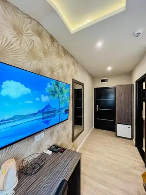 a living room with a large flat screen tv on a wall at Side One Design Hotel Garni in Belgrade