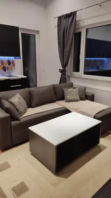 a living room with a couch and a coffee table at Apartman Lena in Arandjelovac