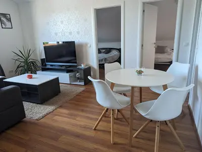 a living room with a white table and chairs at Apartman Lena in Arandjelovac