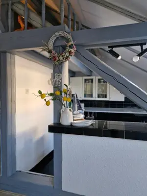 a counter with a vase with flowers on it at Deki & Kolet in Belgrade