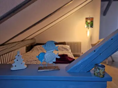 a toy bird sitting on a table next to a bed at Deki & Kolet in Belgrade