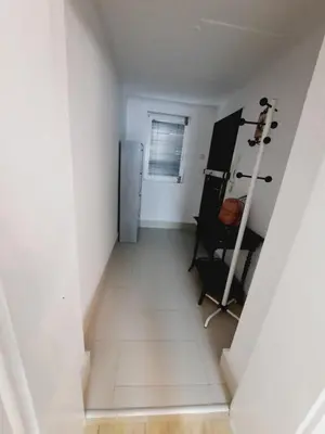 a hallway with a refrigerator in a white room at Deki & Kolet in Belgrade