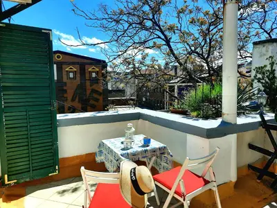 a patio with a table and chairs on a balcony at Deki & Kolet in Belgrade
