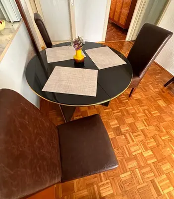 a black table and chairs in a room at Blok in Sajmište