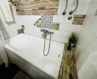 a bathroom with a bath tub with a shower at Blok in Sajmište