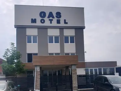a as motel building with cars parked in a parking lot at Motel Gas in Belgrade