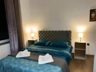 a bedroom with a bed with two white towels on it at Motel Gas in Belgrade