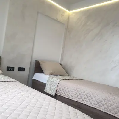 a bedroom with two beds and a window at Motel Gas in Belgrade
