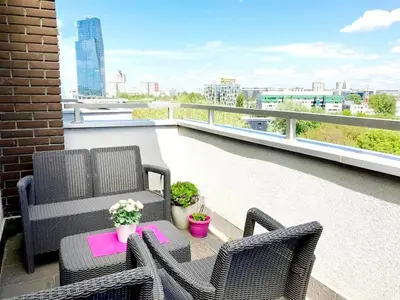 a patio with two chairs and a table on a balcony at Cozy nest SAVADA in Belgrade