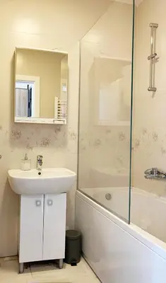 a bathroom with a sink and a shower and a tub at Cozy nest SAVADA in Belgrade