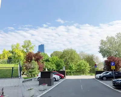a parking lot with cars parked in a park at Cozy nest SAVADA in Belgrade