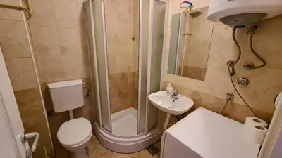 a bathroom with a shower and a toilet and a sink at Voždovac Vitanovacka in Belgrade