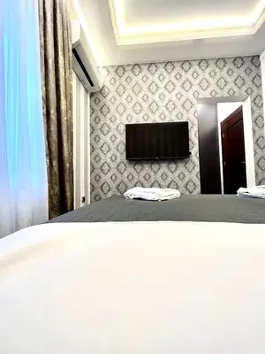 a bedroom with a bed and a tv on a wall at Vinceia in Smederevo