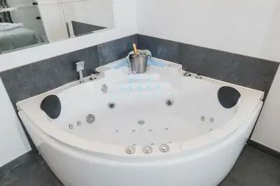 a large white bath tub in a bathroom at Vinceia in Smederevo
