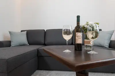 a bottle of wine and two glasses on a table at Vinceia in Smederevo