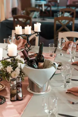 a table with a bucket of wine bottles and candles at Vinceia in Smederevo