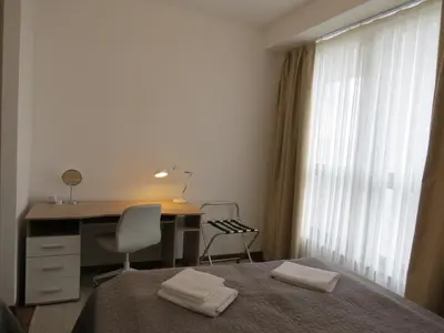 a bedroom with a desk and a bed with a chair at Premium NB Apartment - Belgrade Waterfront in Belgrade