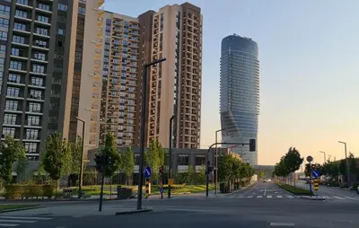 an empty street with tall buildings in a city at Premium NB Apartment - Belgrade Waterfront in Belgrade