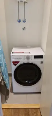 a white microwave oven sitting on top of a cabinet at Premium NB Apartment - Belgrade Waterfront in Belgrade