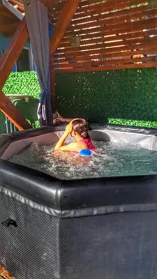a young child is in a hot tub in a swimming pool at Vila Marina in Kovin