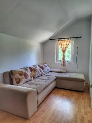 a living room with a couch and a window at Vila Marina in Kovin