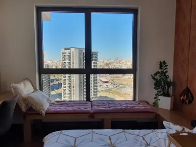 a large window with a purple bench in front of it at AparTwentyOne - Your Home in Belgrade in Belgrade