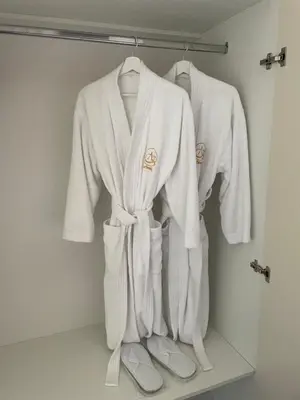 a group of white towels and slippers on a rack at AparTwentyOne - Your Home in Belgrade in Belgrade