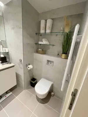a white bathroom with a toilet and a sink at AparTwentyOne - Your Home in Belgrade in Belgrade
