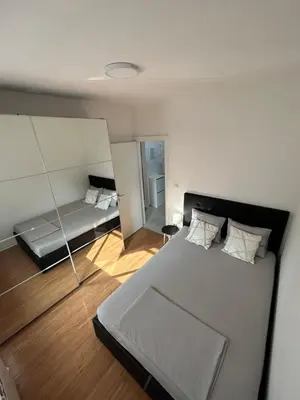 a bedroom with a large bed and a mirror at Delete 4 in Novi Grad