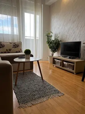 a living room with a tv and a table at Delete 4 in Novi Grad