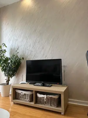 a flat screen tv sitting on top of a wooden entertainment center at Delete 4 in Novi Grad