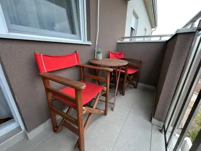 a row of chairs and a table on a balcony at Delete 4 in Novi Grad
