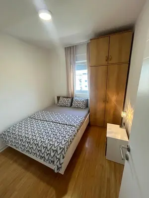a small bedroom with a bed and a wooden floor at Delete 4 in Novi Grad