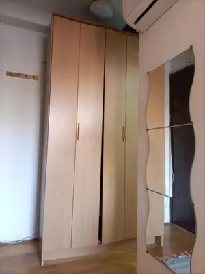 a closet with wooden cabinets in a room at Apartman Lara in Belgrade