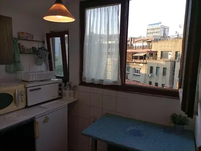 a kitchen with a window with a view of a city at Apartman Lara in Belgrade