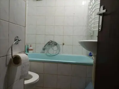 a bathroom with a tub and a toilet and a sink at Apartman Lara in Belgrade