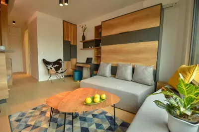 a living room with a couch and a table at STUDIO K district (central BG+private parking) in Belgrade