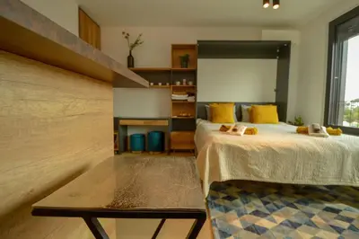 a bedroom with a bed and a large window at STUDIO K district (central BG+private parking) in Belgrade