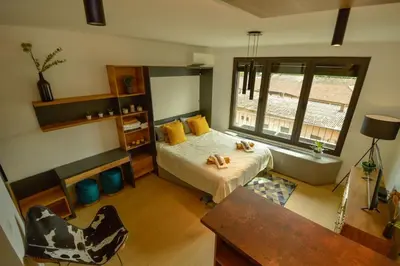 a bedroom with a bed and a large window at STUDIO K district (central BG+private parking) in Belgrade