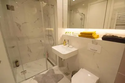 a bathroom with a shower and a toilet and a sink at STUDIO K district (central BG+private parking) in Belgrade
