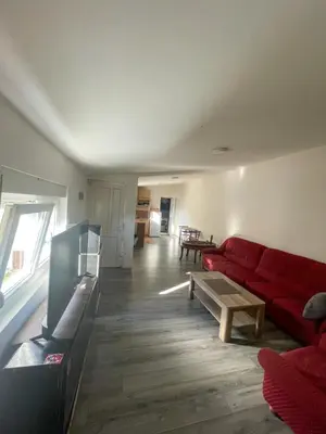 a living room with a red couch and a table at Vracar Apartment in Belgrade