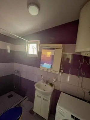 a small bathroom with a sink and a window at Vracar Apartment in Belgrade